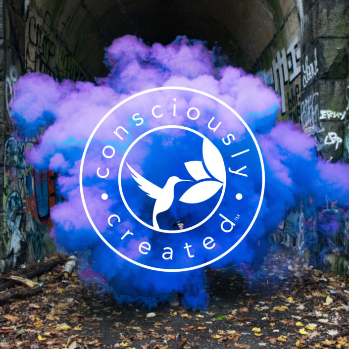 consciously created logo displayed on colorful smoke cloud