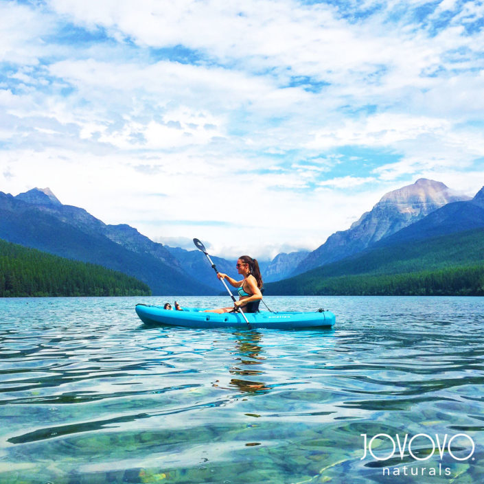 jovovo girl on kayak between lake and mountains