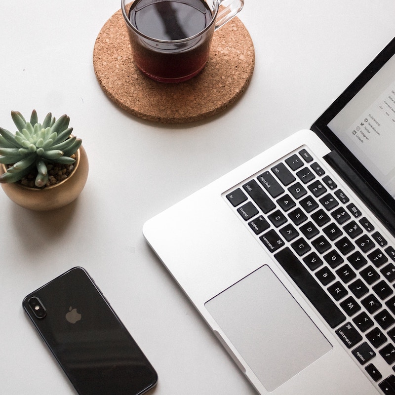 Social media marketing agency photo of a laptop, succulent, phone, and drink